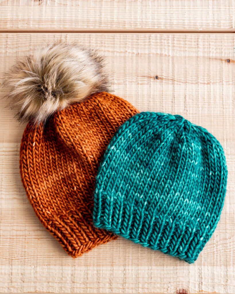 Sustainable Christmas Gifts: handmade knitted beanies in orange and blue